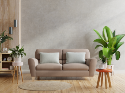 brown-sofa-and-wooden-table-in-living-room-interior-with-plant-concrete-wall